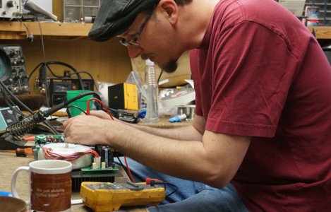 Technician working on amplifier repair